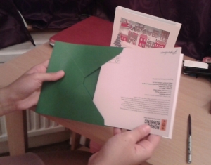 The best way to place a card in an envelope: spine down, back showing.